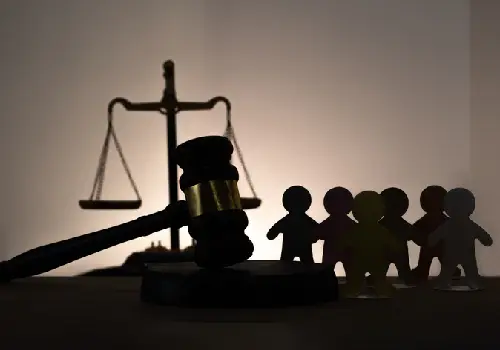 A silhouette of a gavel with a group of figures in the background, representing legal representation for groups of people, part of the work of a civil rights attorney for Augusta GA