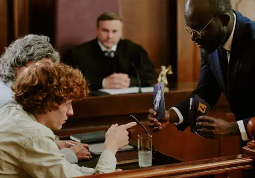 A criminal defense attorney in Augusta GA showing evidence to a client and asking questions during a court case